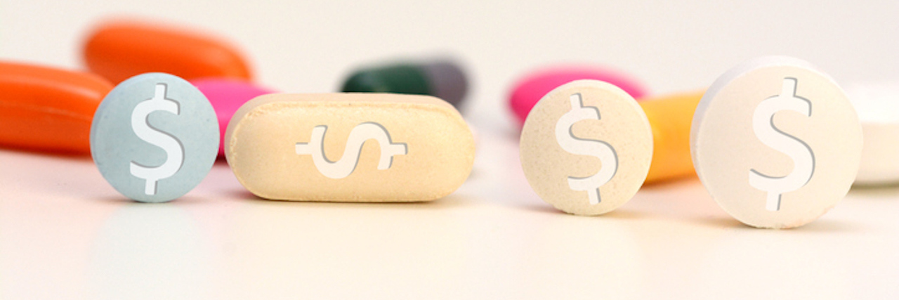 Health care cost concept with multicolored medical drugs with us dollar symbol