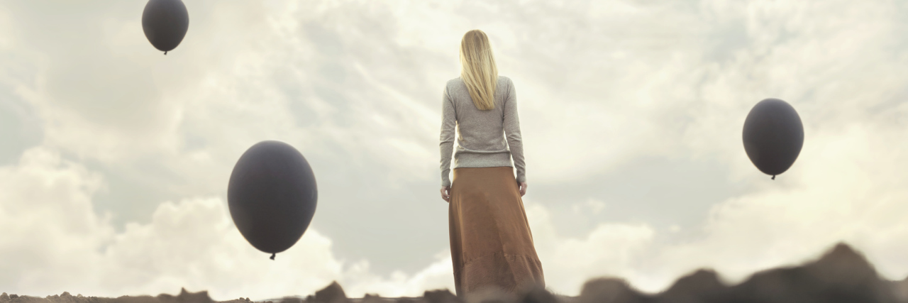 How to Stop Hating Yourself When You Have a Mental Health Relapse lonely woman walking towards infinity in a surreal place