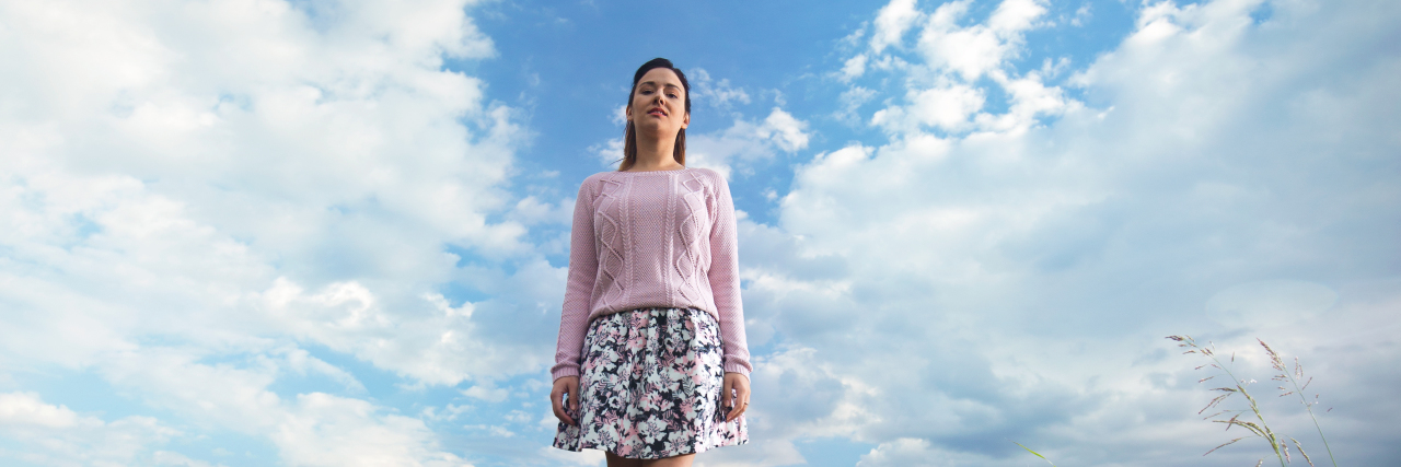 What 'I'm OK' Really Means When You Have a Chronic Illness Young woman walking on railway track.