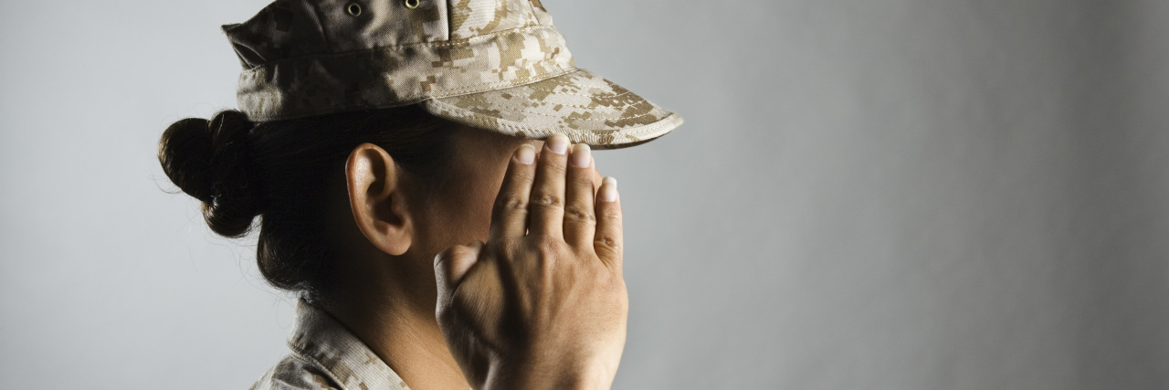 Women Veterans at Heightened Risk for Breast Cancer A woman U.S. marine is saluting.
