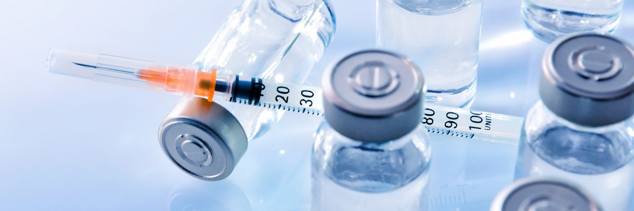 NHS Funding for Metreleptin Faces Rejection vials with medication and a syringe with a needle