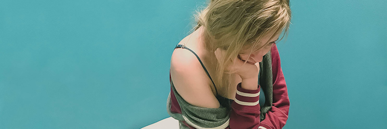 KHN: Despite Federal Law, Rape Victims Get Billed for Forensic Exams Young ill woman sits on an exam table in a doctor office