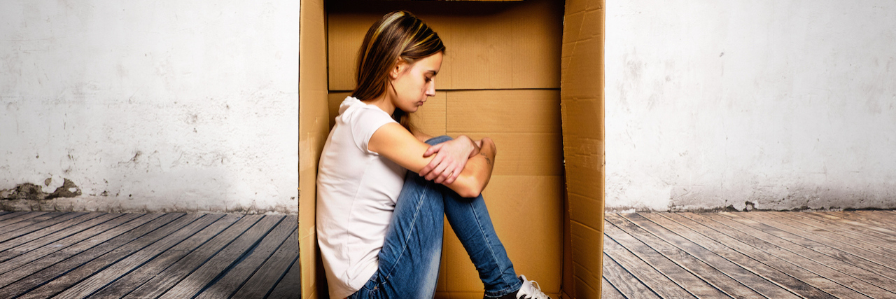 Trauma From Involuntary Psychiatric Hospitalization A woman sitting in a box