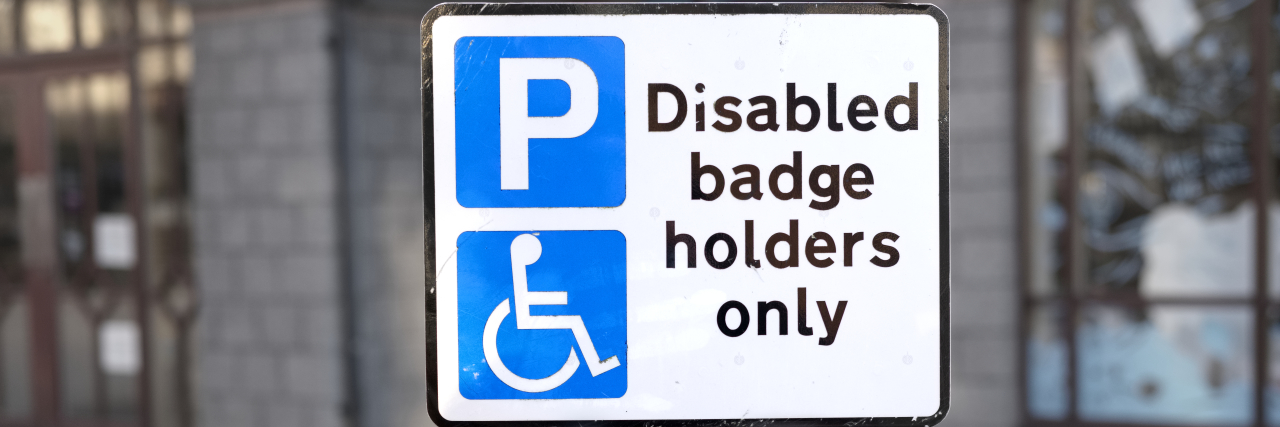 Disabled badge holders only sign and parking space.