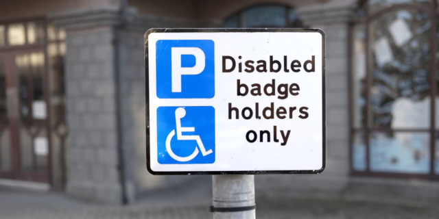 Disabled badge holders only sign and parking space.