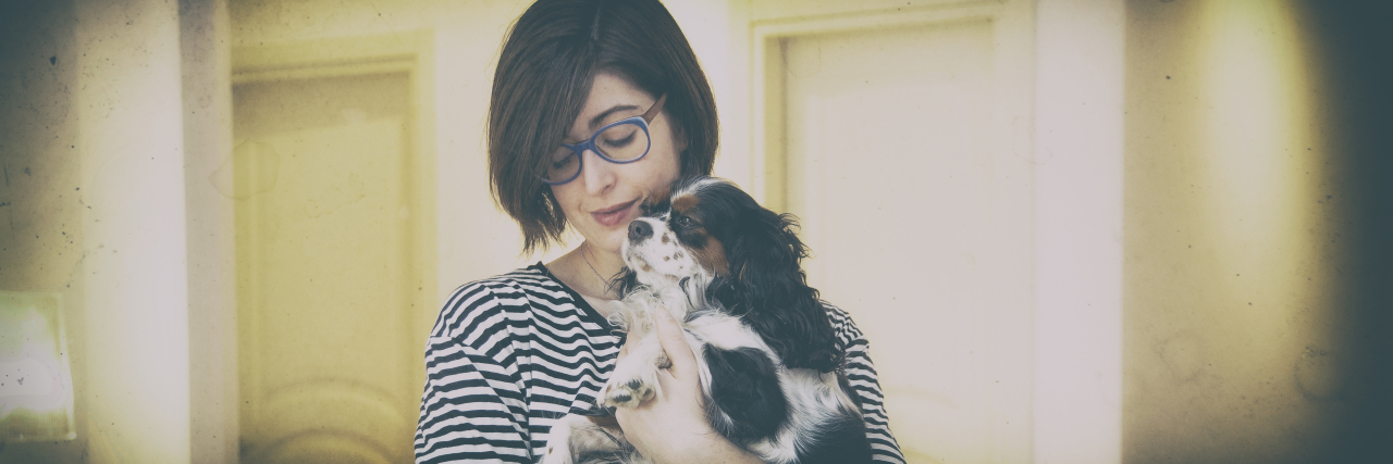 Young woman with Cavalier King Charles Spaniel dog.