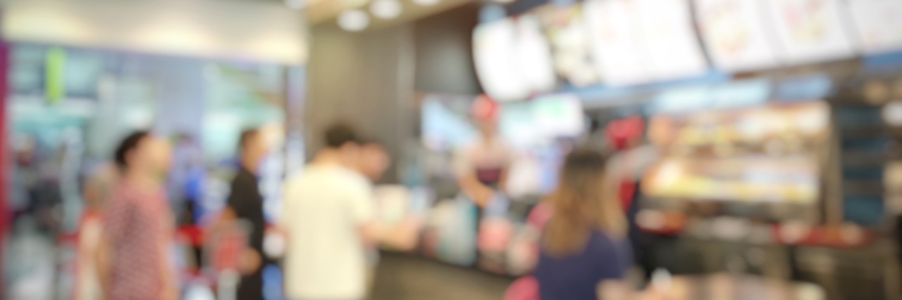 Indiana University Lecturer Verbally Abused Worker With Disabilities People in line at fast food restaurant.