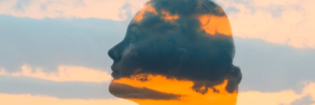 Double exposure of woman's face and sunset.