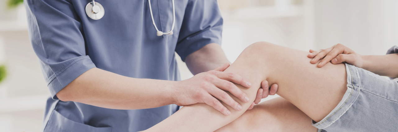 Doctor examining patient's leg.