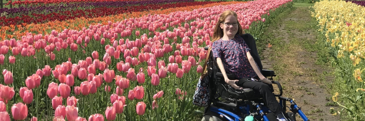 Laura C. Robb, sitting in a field of tulips in Holland, Michigan