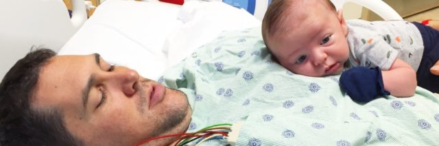 man in hospital with newborn baby