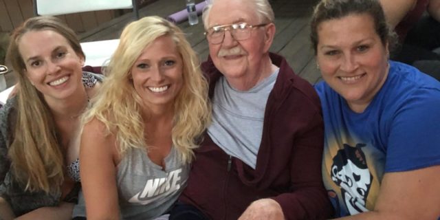 photo of contributor and two other women sitting beside an elderly man