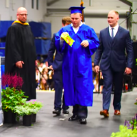 Autistic student Jack Higgins walks at his Carmel High School graduation in New York
