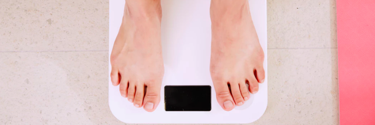 How Fat-Shaming Affects Patients Who Gain Weight feet on a scale