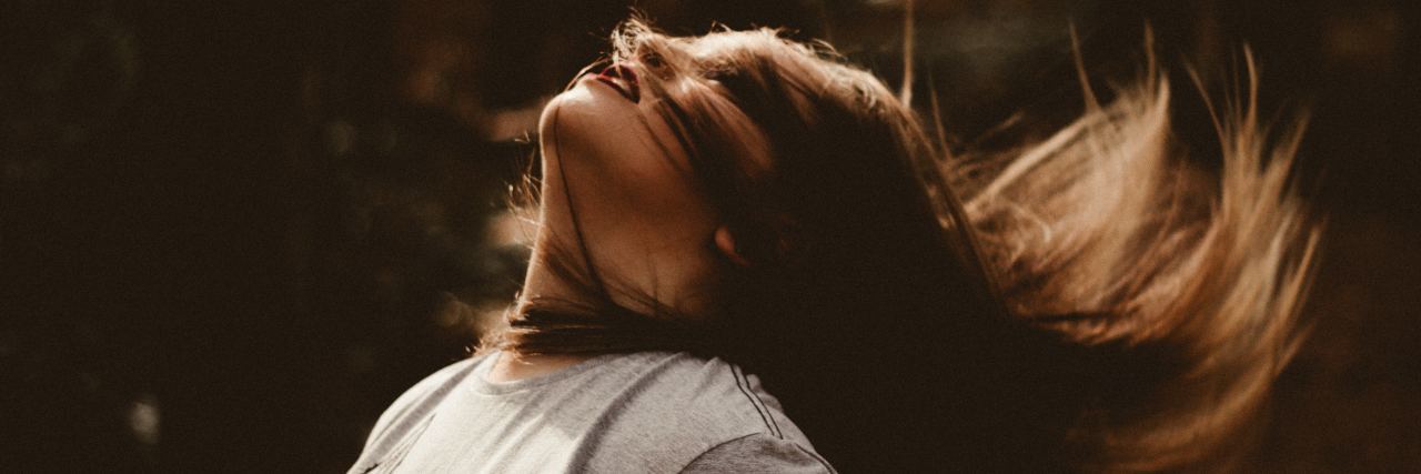 How Self-Harm Scars Affect Your Life After Recovery photo of young woman flipping hair back in sunlight