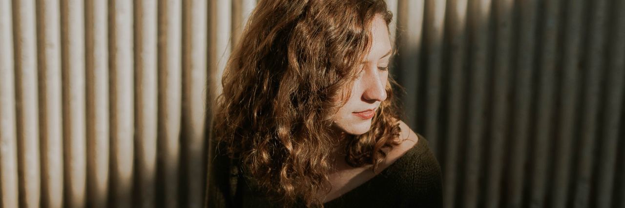 Understanding Why Mindfulness Can Help Me With My Mental Health photo of woman sitting on floor in shadow with eyes closed