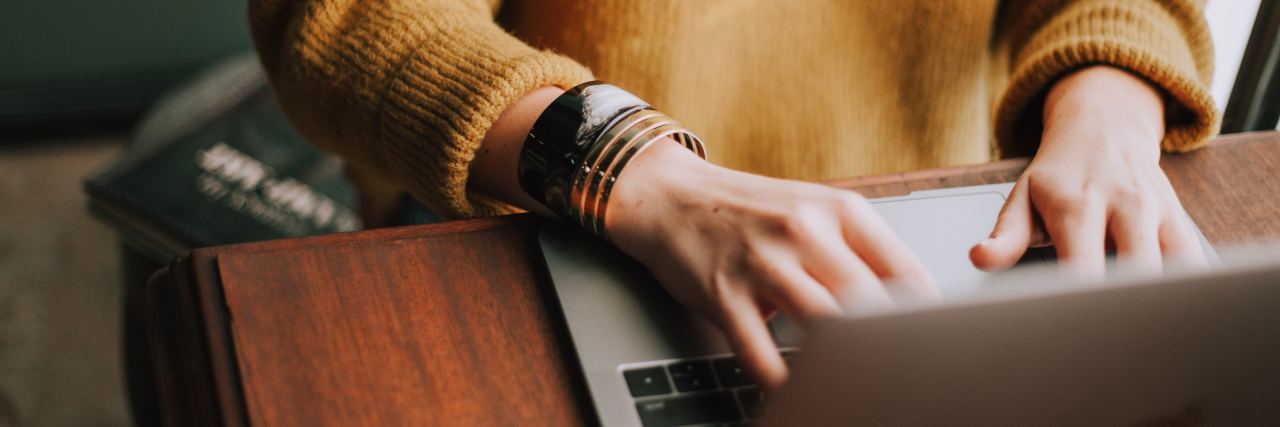Borderline Personality Disorder Affects My Writing close up photo of woman in sweater writing on laptop