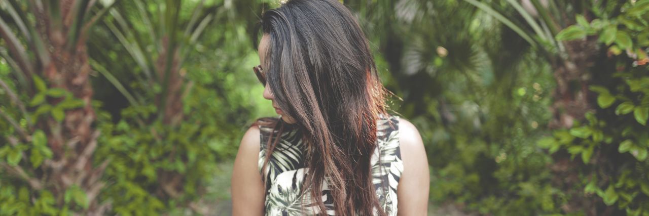 What Someone Said to Help When I Was Suicidal and Struggling Alone woman alone facing away from camera standing among palm trees