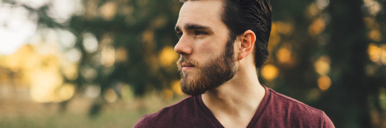 Reuniting With My Alcoholic Father Towards the End of His Life A man with a beard looking to the side, standing outside