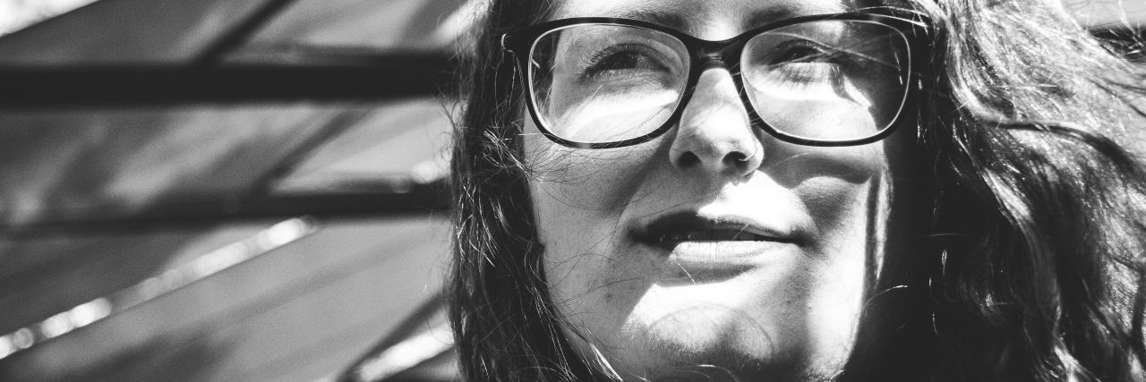 Hearing 'You're So Brave' When You're Chronically Ill woman wearing glasses and smiling