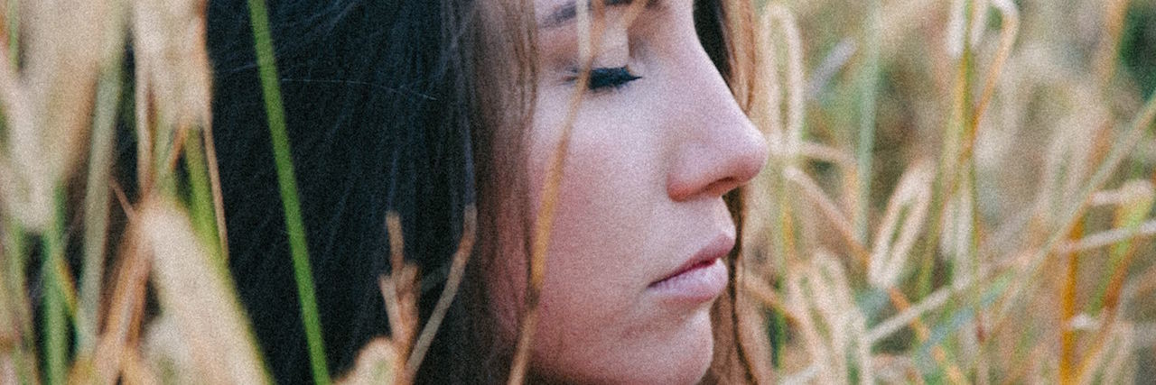 What to Do When It Feels Like You're Life Is Falling Apart A woman sitting in a field with her eyes closed