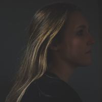 photo of young blonde woman in profile view looking sad or anxious