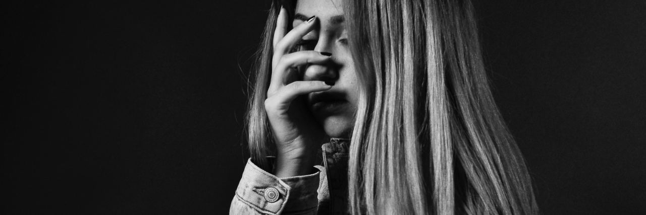 7 Lies PTSD Makes Me Believe (and the 1 Truth I Hold Onto) Woman with her hand over her face