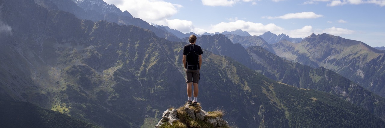 Can Someone With Depression Be an Entrepreneur? photo of man on top of mountain alone standing on rock