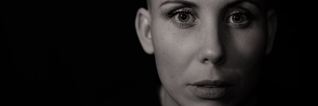 Why You Shouldn't Say You Have PTSD When You Don't black and white photo of woman with short hair looking into camera with serious expression
