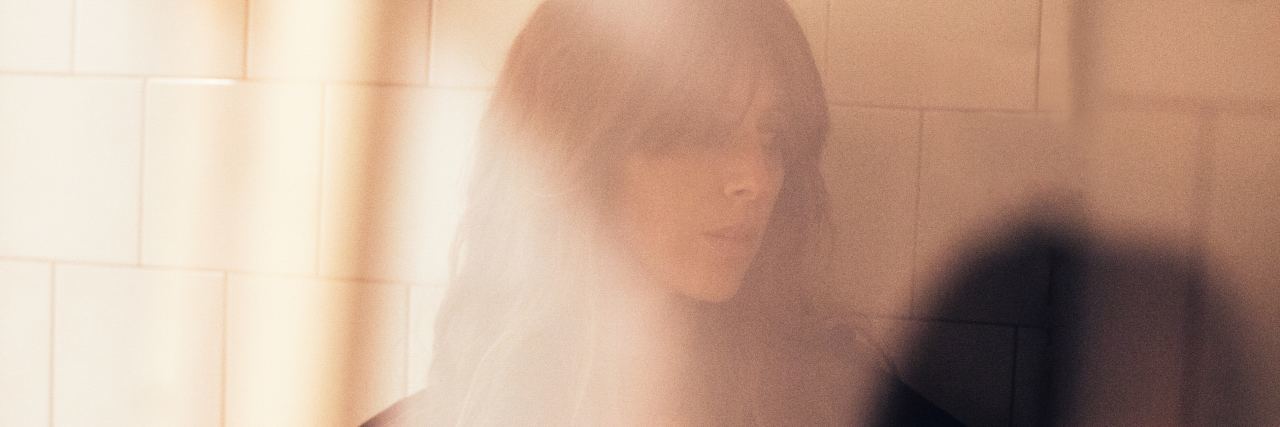 How to Be a Mother With Childhood Emotional Abuse blurred photo of woman with long hair looking sad