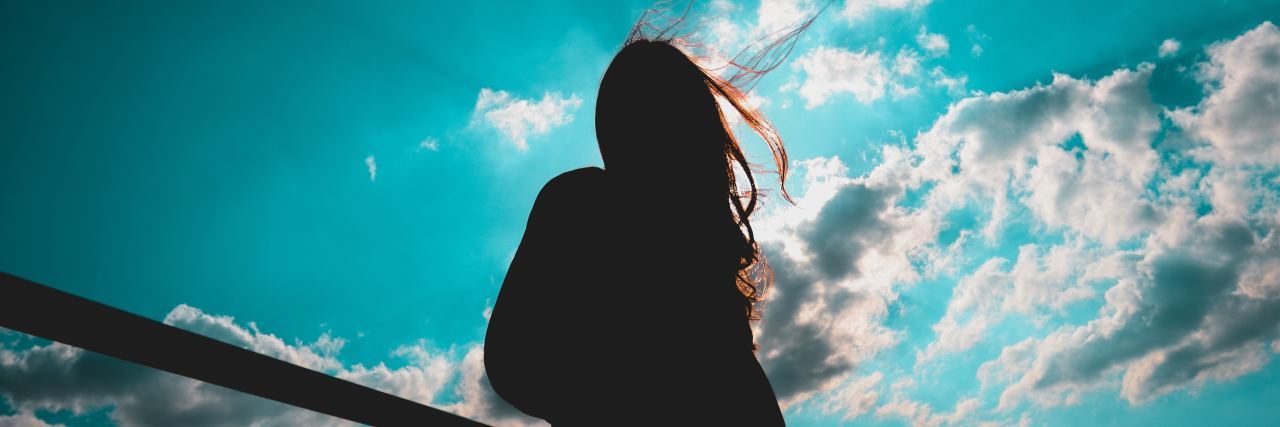 silhouette of woman looking at sky