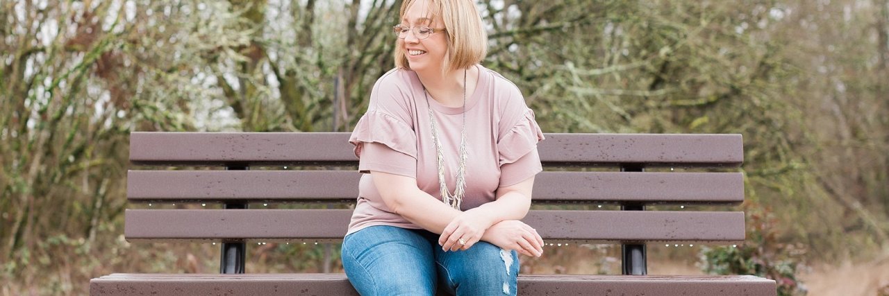 Why Do I Wake up Not Knowing Who I Am? photo of woman sitting on bench smiling with eyes closed