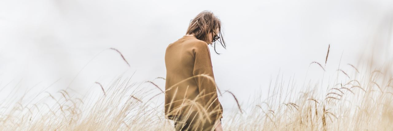 4 Ways I Coped With the 'Suffocating' Loneliness After My Divorce lonely woman in field