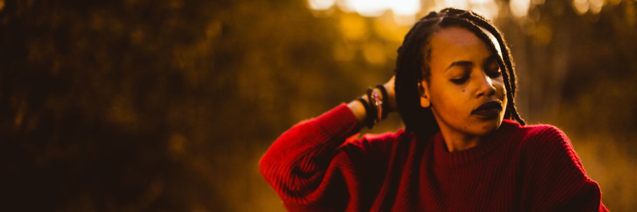 Being Chronically Ill and Missing a Social Life woman looking to the side, walking in the woods