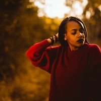 woman looking to the side, walking in the woods