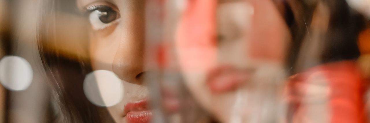 Identity Isn't the 'Issue' With Dissociative Identity Disorder double exposure photo of woman looking into camera