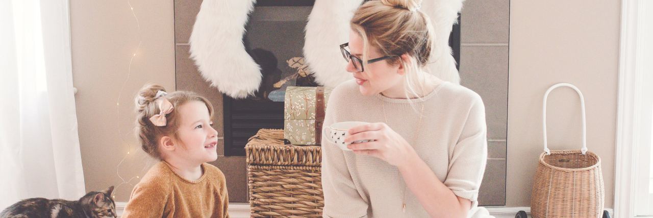 Teaching My Young Daughter About Emotions and Mental Health photo of mother and young daughter having tea party on floor