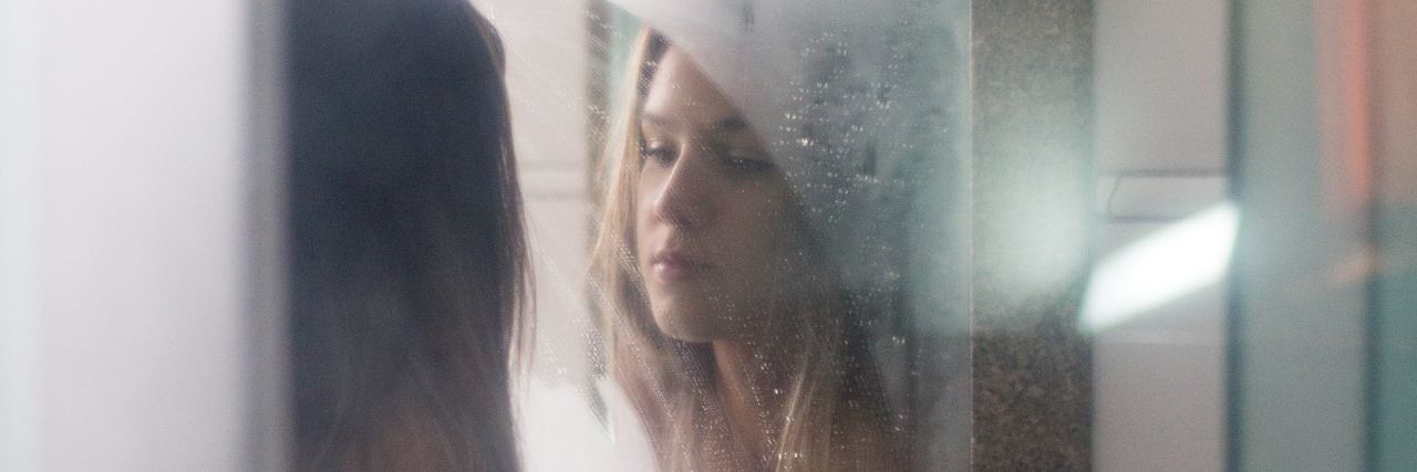 How Water Helps My Anxiety and Panic Attacks photo of young blonde woman looking into steamy bathroom mirror