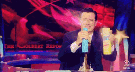 Image of Steven Colbert from "The Colbert Report" spraying two cans of disinfectant everywhere.