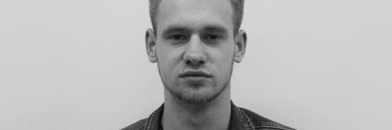 What Someone With Depression Really Means black and white photo of serious man looking into camera