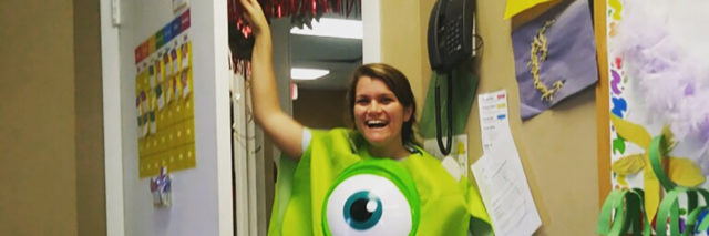 Nicole in her classroom wearing a funny Monsters Inc costume.