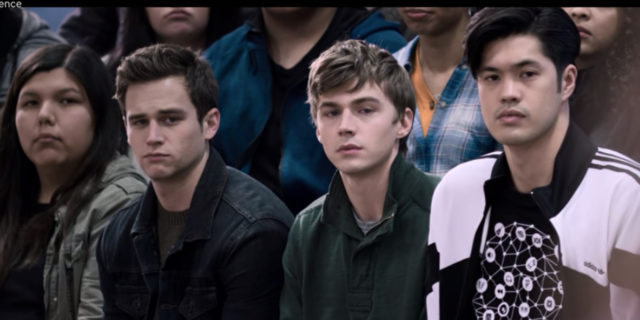 Zach, Alex and Justin sitting in an auditorium.
