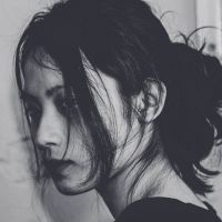 woman with hair in face looking to left