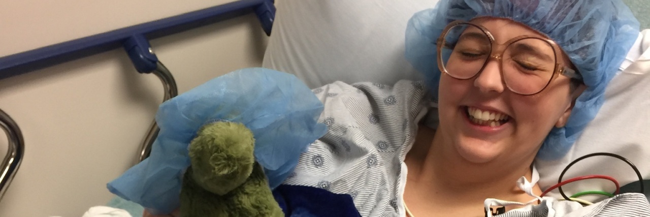 Communicating to Family and Friends About Your Chronic Illness the author in a hospital bed smiling