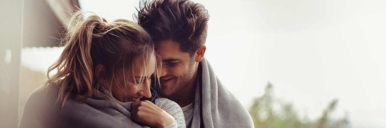 Chronic Illness Challenges and Strengthens My Relationship Man and woman standing together and wrapped in blanket