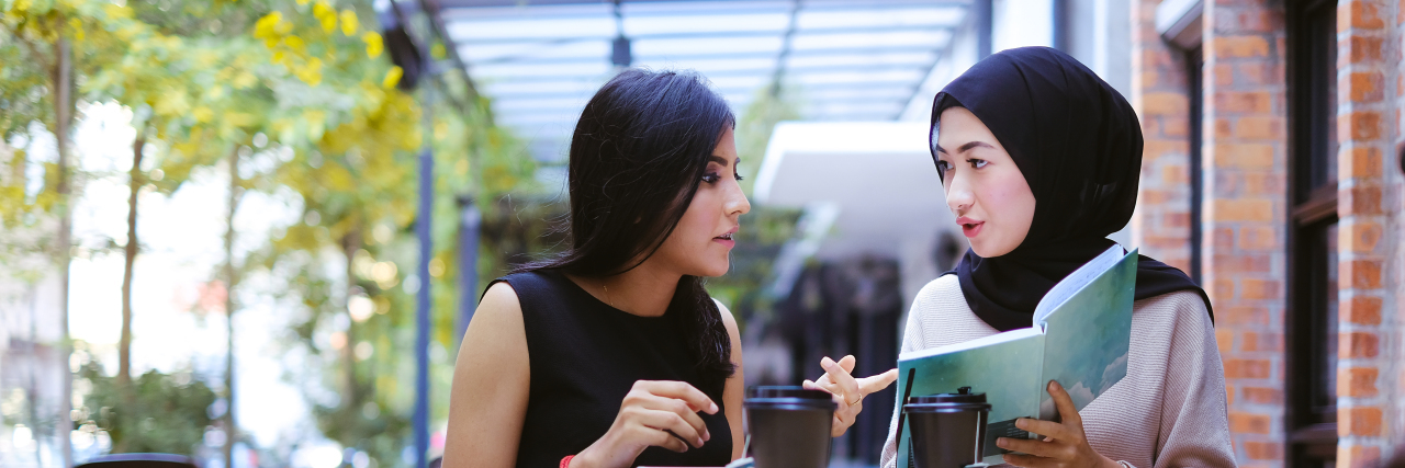 What to Do If Disability Accommodations Are Not Being Met in College Close up picture of two young female having group study outside cafe