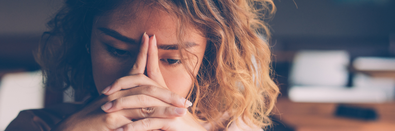 How the Psychological Effects of Diabetes Can Lead to Diabulimia Closeup of sad young woman at cafe leaning head on clasped hands and staring into vacancy. Tired freelancer feeling burnout. Stress and bad news concept