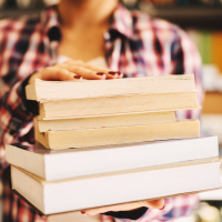 Close up of hands holding books
