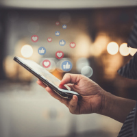 Hand using smartphone with Social media concept.