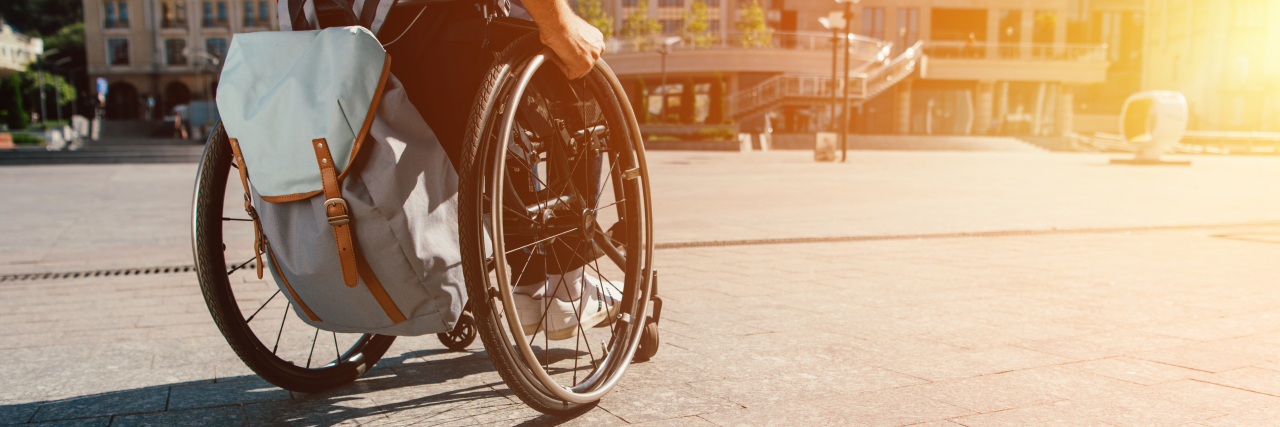 My Cerebral Palsy Is Not a Trauma Person in a manual wheelchair outdoors.